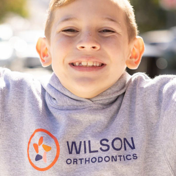 Patient wearing a Wilson Orthodontics hoodie